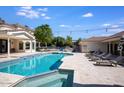 Resort-style pool with a tanning ledge and lush landscaping, perfect for outdoor living at 10440 E Larkspur Dr, Scottsdale, AZ 85259