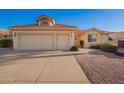 Charming single-story home featuring a terracotta roof, and a spacious three-car garage and easy-to-maintain landscaping at 10901 E Sunnydale Dr, Sun Lakes, AZ 85248