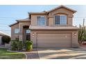 Two-story stucco home showcasing a well-manicured lawn, desert landscaping, and an attached two-car garage at 1119 W Heather Ave, Gilbert, AZ 85233