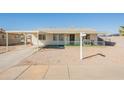 Charming single-story home with a front yard featuring decorative gravel and a covered carport for convenient parking at 12010 N 113Th Ave, Youngtown, AZ 85363