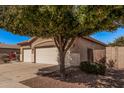 Charming single-story home featuring a well-maintained front yard and a convenient two-car garage at 12622 W Apodaca Dr, Litchfield Park, AZ 85340