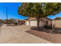 Charming single-story home featuring a well-maintained front yard and a convenient two-car garage at 12622 W Apodaca Dr, Litchfield Park, AZ 85340