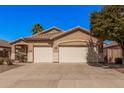 Charming single-story home featuring a well-maintained front yard and a convenient two-car garage at 12622 W Apodaca Dr, Litchfield Park, AZ 85340