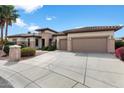 Lovely single-story house featuring a spacious driveway and a well-maintained front lawn at 16769 W Brookhaven Ct, Surprise, AZ 85387