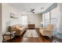 Comfortable living room with wood floors, modern ceiling fan, and neutral decor, creating a cozy atmosphere at 1893 S Sinova S Ave, Gilbert, AZ 85295