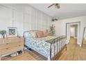 Bright bedroom with wood-style flooring, decorative wall paneling, and a cozy ceiling fan at 20837 N 23Rd Pl, Phoenix, AZ 85024