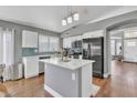 Modern kitchen features white cabinets, stainless steel appliances, and a central island at 20837 N 23Rd Pl, Phoenix, AZ 85024