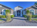 Inviting home exterior with stone accents, manicured bushes and elegant entrance at 22406 S 173Rd Way, Gilbert, AZ 85298