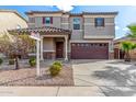 Beautiful front exterior featuring desert landscaping and a two-car garage at 25845 W Lynne Ln, Buckeye, AZ 85326