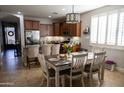 Bright kitchen and dining area showcasing a table, island, and stainless steel appliances at 29902 N 71St Ave, Peoria, AZ 85383