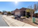 Street view of a well-maintained home with desert landscaping and a two-car garage and neutral tones at 29986 N Jillian Dr, San Tan Valley, AZ 85143