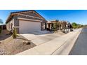 Street view of a desert landscaped home with a two car garage and gray exterior at 29986 N Jillian Dr, San Tan Valley, AZ 85143