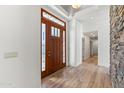 Welcoming foyer with wood floors, stone accent wall, and a view into the home at 302 W Stella Ln, Phoenix, AZ 85013