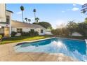 Inviting backyard pool with clear blue water and sunny views of the home's exterior at 302 W Stella Ln, Phoenix, AZ 85013