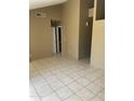 Spacious living room features tile flooring, neutral paint and an open doorway, with abundant natural light at 5114 W Joan De Arc Ave, Glendale, AZ 85304