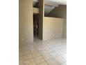 Spacious living room featuring neutral walls, tiled floors, and high ceilings with bright, natural light at 5114 W Joan De Arc Ave, Glendale, AZ 85304