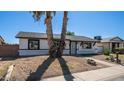 Charming single-story home featuring a low-maintenance yard and palm trees at 5327 W Saint Moritz Ln, Glendale, AZ 85306