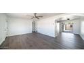 Bright living room featuring new luxury vinyl floors and a ceiling fan at 5327 W Saint Moritz Ln, Glendale, AZ 85306