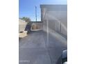 View of the home's shaded carport area, providing covered parking and access to the backyard at 6617 W Peck Dr, Glendale, AZ 85301