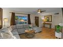 Comfortable living room featuring a large window with natural light, stylish decor, and hardwood floors at 6704 N 10Th Pl, Phoenix, AZ 85014