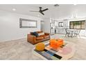 Bright living room with tile floors, ceiling fan, and a combined kitchen/dining area at 7531 E Belleview St, Scottsdale, AZ 85257