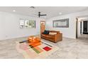 Bright living room featuring tile floors, modern decor, and ample natural light at 7531 E Belleview St, Scottsdale, AZ 85257