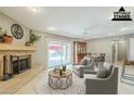 Inviting living room featuring a fireplace, sliding glass doors to the backyard, and elegant furnishings at 7629 N Via De La Campana --, Scottsdale, AZ 85258