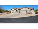 Single-story home featuring desert landscaping, a long driveway, and a neutral color palette at 7910 E Snowdon Cir, Mesa, AZ 85207