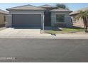Charming single-story home with a well-manicured lawn and a two-car garage at 9121 W Alvarado St, Phoenix, AZ 85037