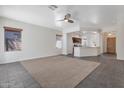 Bright living room with tile flooring, ceiling fan, and an open layout to the kitchen at 9121 W Alvarado St, Phoenix, AZ 85037