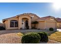 Well-maintained home with a tile roof, desert landscaping, and a welcoming front entrance at 9853 W Irma Ln, Peoria, AZ 85382