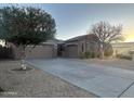 A lovely exterior view of the home, featuring a well-maintained lawn and attached garage at 10731 W Wikieup Ln, Peoria, AZ 85373