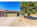 Charming single-story home with desert landscaping and neutral colored exterior at 11026 E Nopal Ave, Mesa, AZ 85209