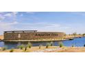 A landscaped entrance to Amarillo Creek, showcasing the community's serene waterfront at 11675 N Siders Ln, Maricopa, AZ 85139