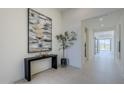 Bright home foyer with a black console table and modern artwork at 12322 E Black Rock Rd, Scottsdale, AZ 85255