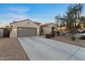 Charming single-story home with a desert-landscaped front yard and a spacious driveway leading to the garage at 13583 S 177Th Ln, Goodyear, AZ 85338