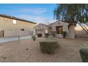 Attractive home with desert landscaping and a two-car garage, framed by mature trees and shrubs at 13583 S 177Th Ln, Goodyear, AZ 85338