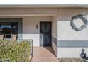 Inviting front entrance with security door, decorative wreath, and meticulously maintained desert rock landscaping at 13914 W Terra Vista Dr, Sun City West, AZ 85375