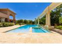 Luxury pool and hot tub, set in travertine, featuring a colonnade and a relaxing backyard escape at 1440 N 40Th St # 4, Mesa, AZ 85205