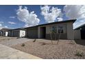 Charming single-story home with a two-car garage, low maintenance desert landscaping, and paver driveway at 15761 W Beryl Ave, Waddell, AZ 85355