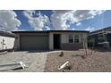 Charming single-story home with a two-car garage and a low-maintenance landscaped front yard at 15761 W Beryl Ave, Waddell, AZ 85355