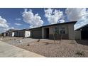 A row of single-story homes featuring low-maintenance landscaping and two-car garages at 15761 W Beryl Ave, Waddell, AZ 85355