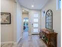 Inviting foyer featuring tile floors, console table with mirror, and lots of natural light at 17721 E Bismark Lake Ct, Rio Verde, AZ 85263