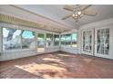 Bright sunroom featuring brick accents, tile flooring, and lots of natural light at 18034 N Highwood Ct, Sun City, AZ 85373