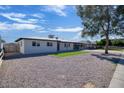 Charming single-story home with low maintenance rock landscaping, artificial grass, and covered parking at 1913 E 1St Ave, Mesa, AZ 85204