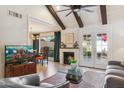 Living room with exposed beam ceiling, a fireplace, and views into the dining area at 1920 E Maryland Ave # 16, Phoenix, AZ 85016