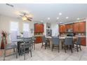 The kitchen showcases an island breakfast bar, stainless appliances, and an adjacent dining area at 21600 N 106Th Ln, Peoria, AZ 85382
