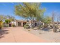 Southwest home with long driveway, desert landscaping, and barrel tile roof at 22970 N 79Th Pl, Scottsdale, AZ 85255