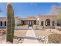 Southwest home featuring desert landscaping with barrel tile roof at 22970 N 79Th Pl, Scottsdale, AZ 85255