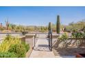 Home's entrance with gated courtyard, desert landscape, and mountain views at 22970 N 79Th Pl, Scottsdale, AZ 85255